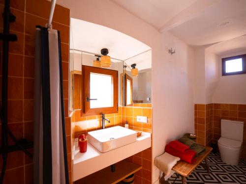 a bathroom with a sink and a mirror at Cortijo Negretti in Herrera de Alcántara