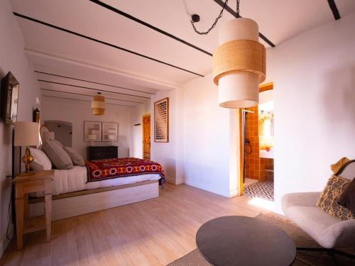 a bedroom with a bed and a living room at Cortijo Negretti in Herrera de Alcántara