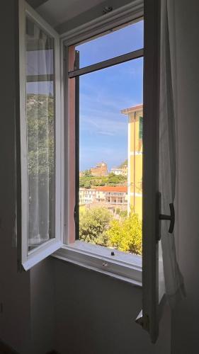 an open window with a view of a city at Harmony Affittacamere in Riomaggiore