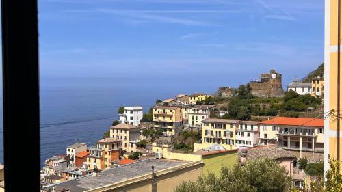 a group of buildings on a hill next to the ocean at Harmony Affittacamere in Riomaggiore