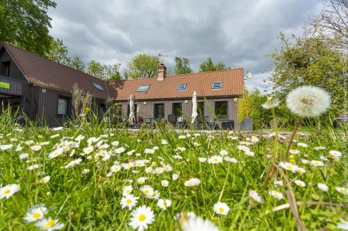 a field of flowers in front of a house at Le Domaine de Wail Legends Resort in Wail