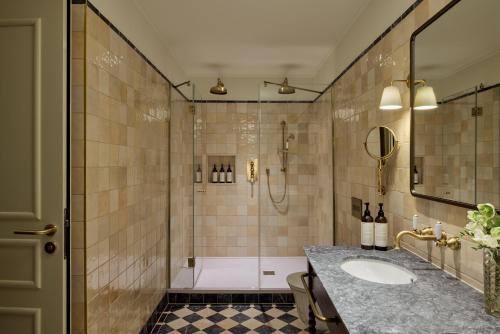 a bathroom with a shower and a sink at Miiro Palais Rudolf in Vienna