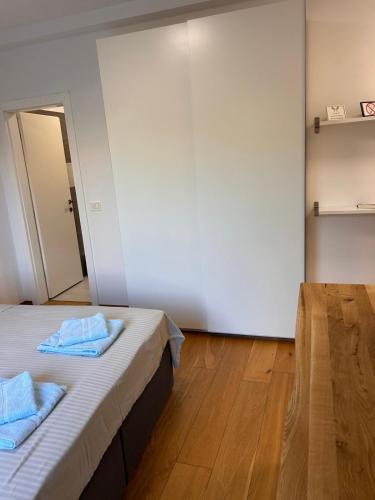 a room with two beds with blue towels on them at Kseni Accommodation in Rovinj