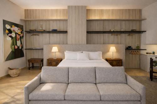 a bedroom with a bed and a couch at Convivium 5 - High-end Studio in Gemmayze in Beirut