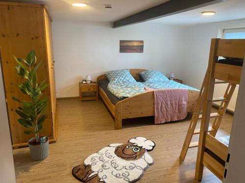 a bedroom with a bed with a sheep on the floor at NEU! Ferienwohnung Bruno in Gersfeld