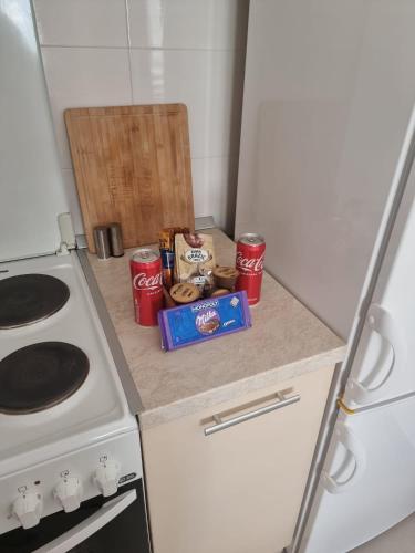 a kitchen with a counter with food and soda cans at Vels Suite - Cozy Oasis & Free Parking in Voždivac