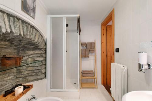 a bathroom with a sink and a stone wall at Locanda delle Miniere in Ollomont