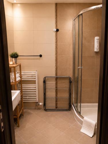 a bathroom with a shower and a sink at Komnata Bešeňová - Apartmán 344 in Bešeňová