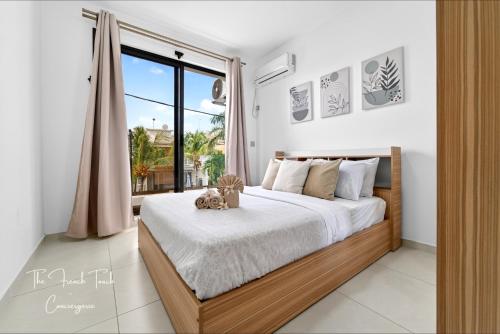 a bedroom with a bed with a teddy bear on it at The Jacuzzi Escape in Flic-en-Flac