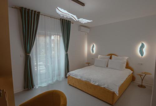 a bedroom with a bed and a window at Butterfly in Hunedoara