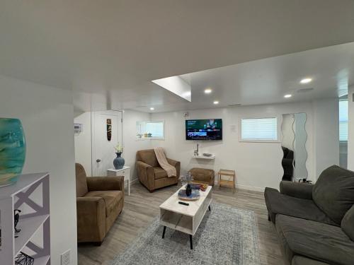 a living room with two couches and a tv at Silverado Suite Modern Quiet 2BR Queen's Downtown in Kingston