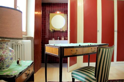 a bathroom with a sink and a chair and a mirror at Villa Adele in Varese