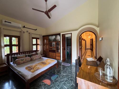 a bedroom with a bed and a table in it at Prangan - The Villa in Chākdaha
