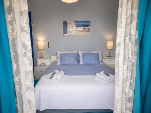 a bedroom with a bed with blue and white curtains at Elia Apartment Garden Oasis With Pool Astros in Paralio Astros