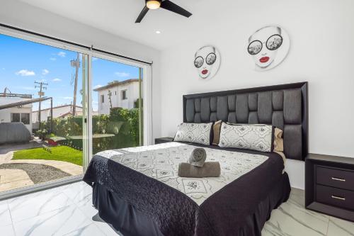 a bedroom with a bed with masks on the wall at Dog-friendly home 3 rows to beach with rooftop deck, pool, & kitchen in Rosarito