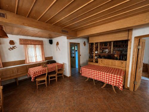a room with two tables and chairs in a house at Zidanica Jakec Wine House & Scenic Views in Podlehnik