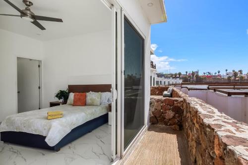 a bedroom with a bed on a balcony at Dog-friendly Home with Partial Ocean View, Heated Pool, Rooftop Terrace in Rosarito