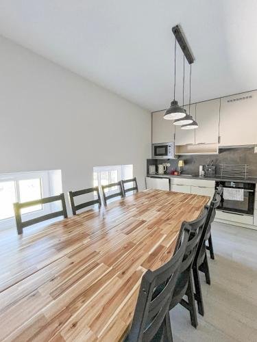a large dining room with a wooden table and chairs at Apartmán Proseč-Obořiště in Nová Cerekev