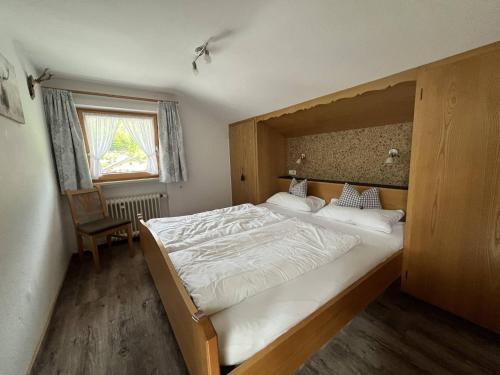 a bedroom with a large bed and a window at Ferienwohnung 2 Am Krepbach in Grainau