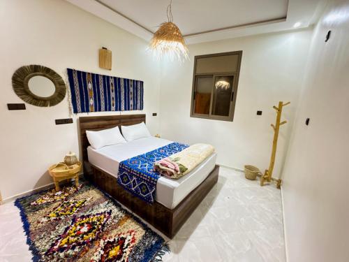 a bedroom with a bed and a rug at Surf Apartment in Tamri Rooftop Local Experience in Tamri