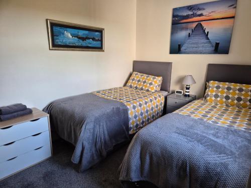 a bedroom with two beds next to each other at Beautiful 2-Bed semi rural cottage enclosed garden in Drummore
