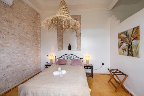 a bedroom with a bed with a cross on it at La Vida Surf - Yoga Villa in Ounara
