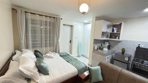 a bedroom with a large bed and a couch at Wattle Residence Ngong in Ngong