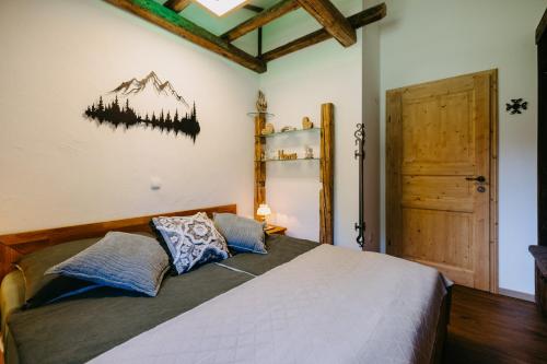a bedroom with a large bed with two pillows at Ferienhaus Weiss in Oberschützen