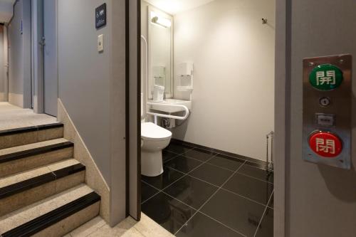 a bathroom with a toilet and a sink at Sotetsu Fresa Inn Tokyo-Akasaka in Tokyo