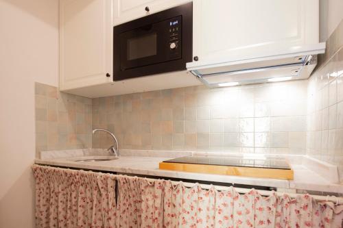 a kitchen with a sink and a microwave at Rio Marina central apartment- 200m dal mare in Rio Marina