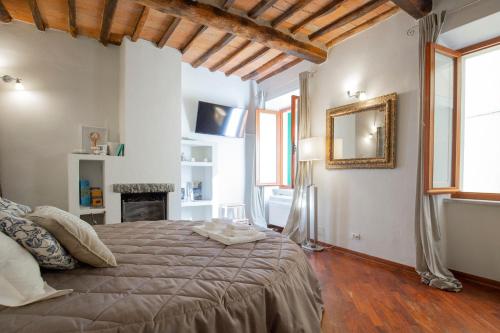 a bedroom with a bed and a mirror on the wall at Rio Marina central apartment- 200m dal mare in Rio Marina
