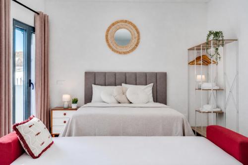 a bedroom with two beds and a mirror on the wall at Studio - Old Town Albufeira in Albufeira