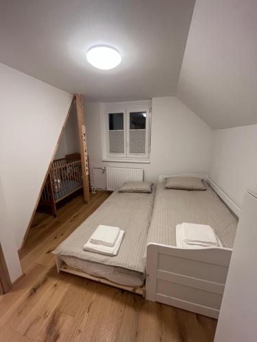 a bedroom with a large bed in a attic at Hiša Čebron in Podnart