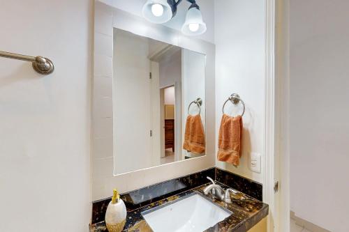 a bathroom with a sink and a mirror at Dog-Friendly Villa with Heated Outdoor Pool, Hot Tub, Streaming, Partial Views in Rosarito