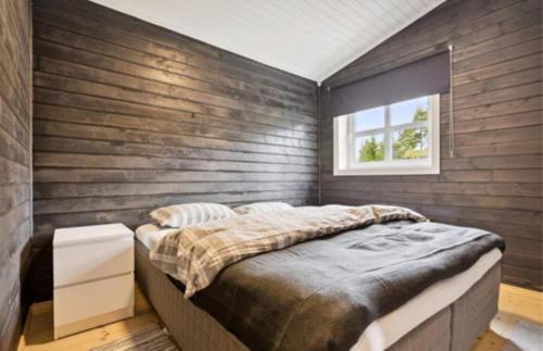 a bedroom with a large bed and a window at Jegertråkket 13 in Sør-Fron