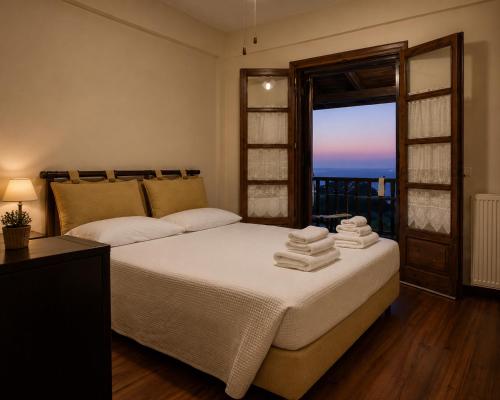 a bedroom with a bed with towels on it at Deja Blue in Mouresi