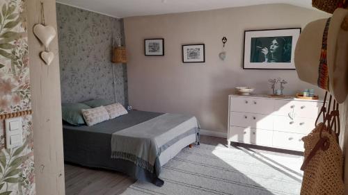 a small bedroom with a bed and a dresser at les hirondelles de Barrou in Saint-Jean-de-Barrou