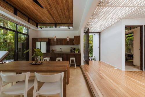 a dining room and kitchen with a table and chairs at Nalu Nosara Pool Villa Sol in San Rafael