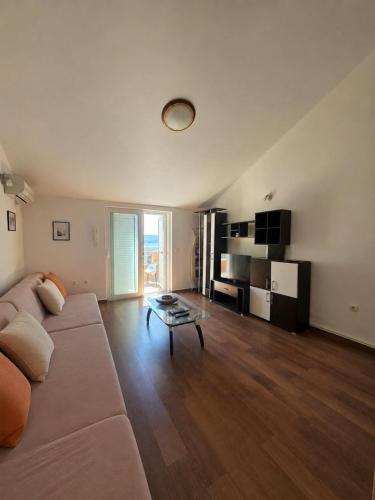 a living room with a couch and a table at Rafailovici Sea View in Rafailovici