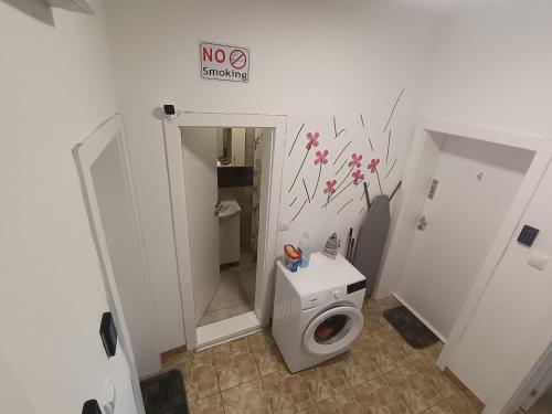 a bathroom with a toilet with flowers on the wall at Soba Za Odmor # in Mladenovac