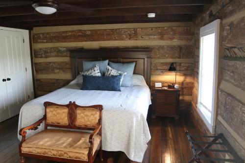 a bedroom with a bed and a wooden wall at The Hutch in Bardstown
