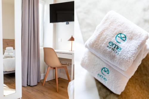 a room with a white towel that says shop at Hospedería Boho Granada by eme hoteles in La Zubia