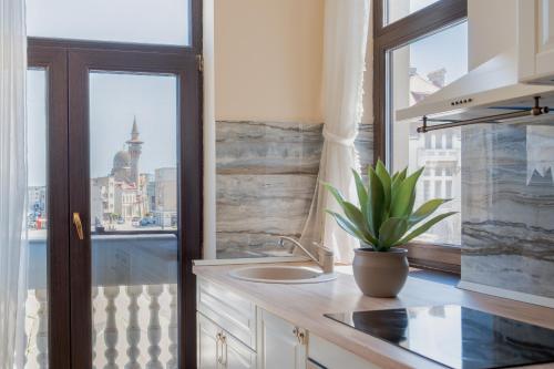 a kitchen with a sink and a window at Next Apartments Constanta in Constanţa