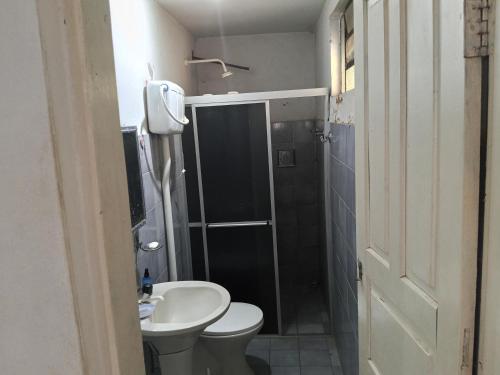 a bathroom with a toilet and a sink and a shower at Pousada Mais E Vida 24h in Teresina