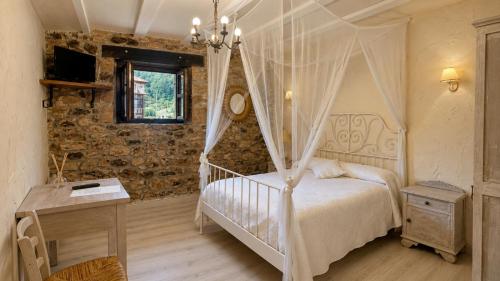 a bedroom with a bed with a canopy at Posadaochohermanas in Las Fraguas