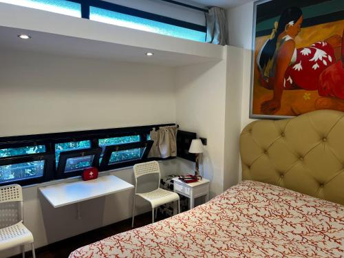 a bedroom with a bed and a table and chairs at Studio Naty in Marina di Massa