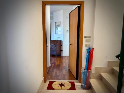 a hallway with a door open to a room with stairs at ZENIT Rooms in Senigallia