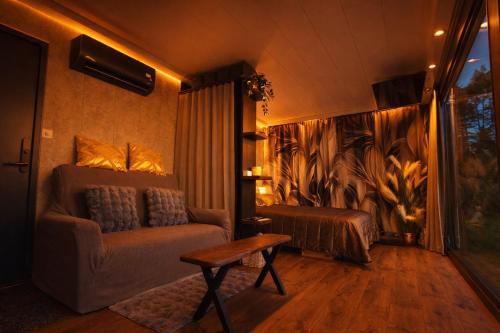 a living room with a couch and a bed at LuigeLaguun in Triigi