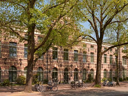 a group of bikes parked in front of a building at YAYS Amsterdam Maritime by Numa in Amsterdam