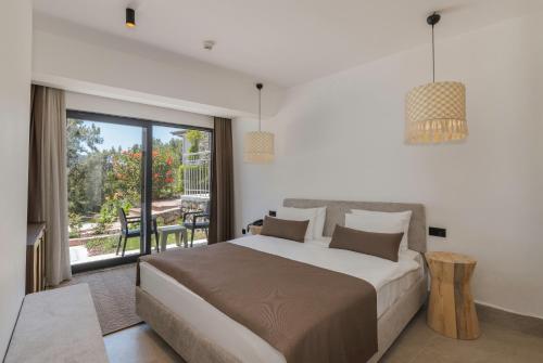 a bedroom with a large bed and a balcony at Hotel Meri All inclusive in Oludeniz